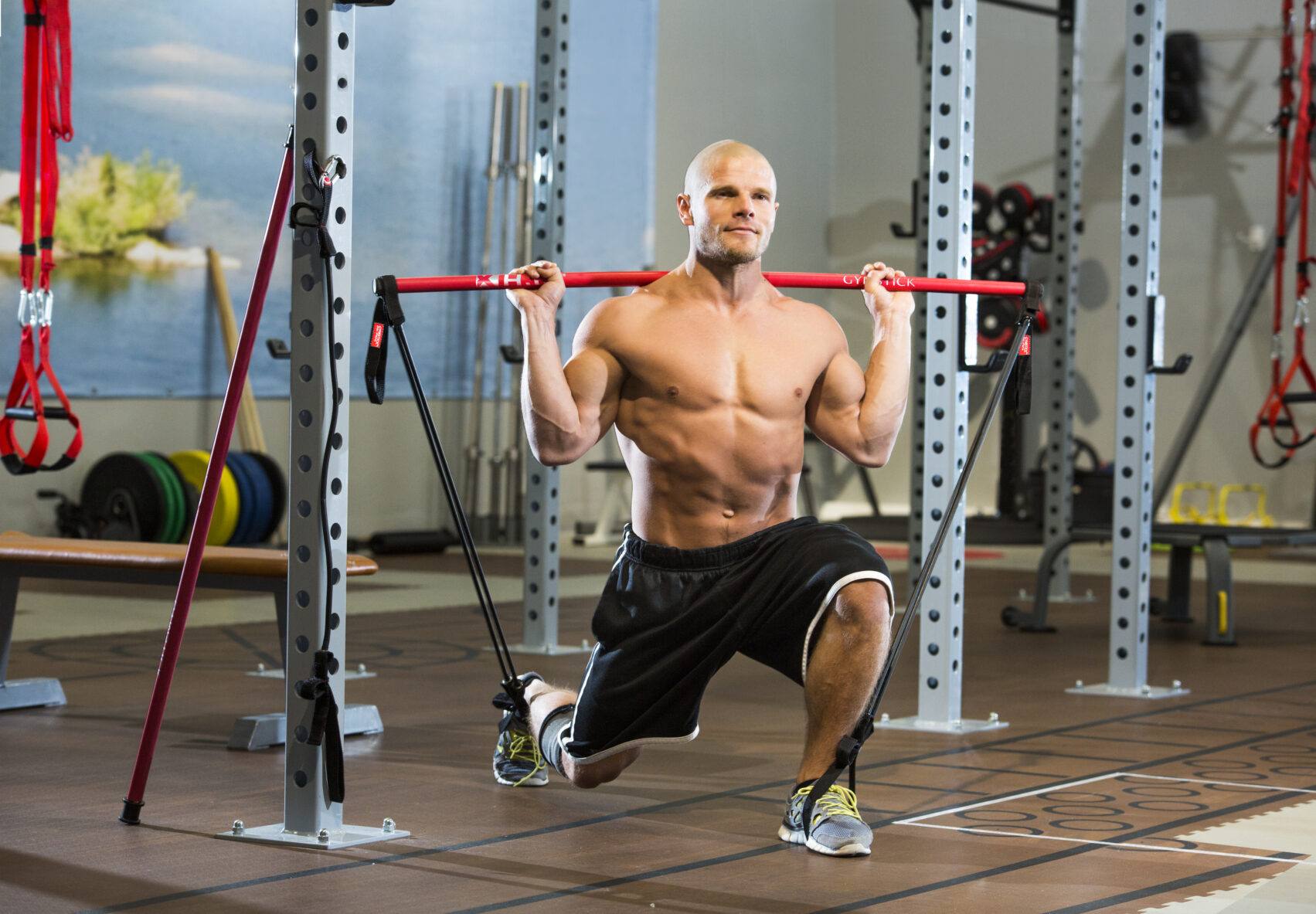 Gymstick Original in red being used in gym by strong muscled man