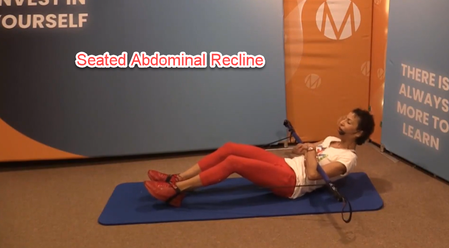 A person lying on a mat with a bar

Description automatically generated